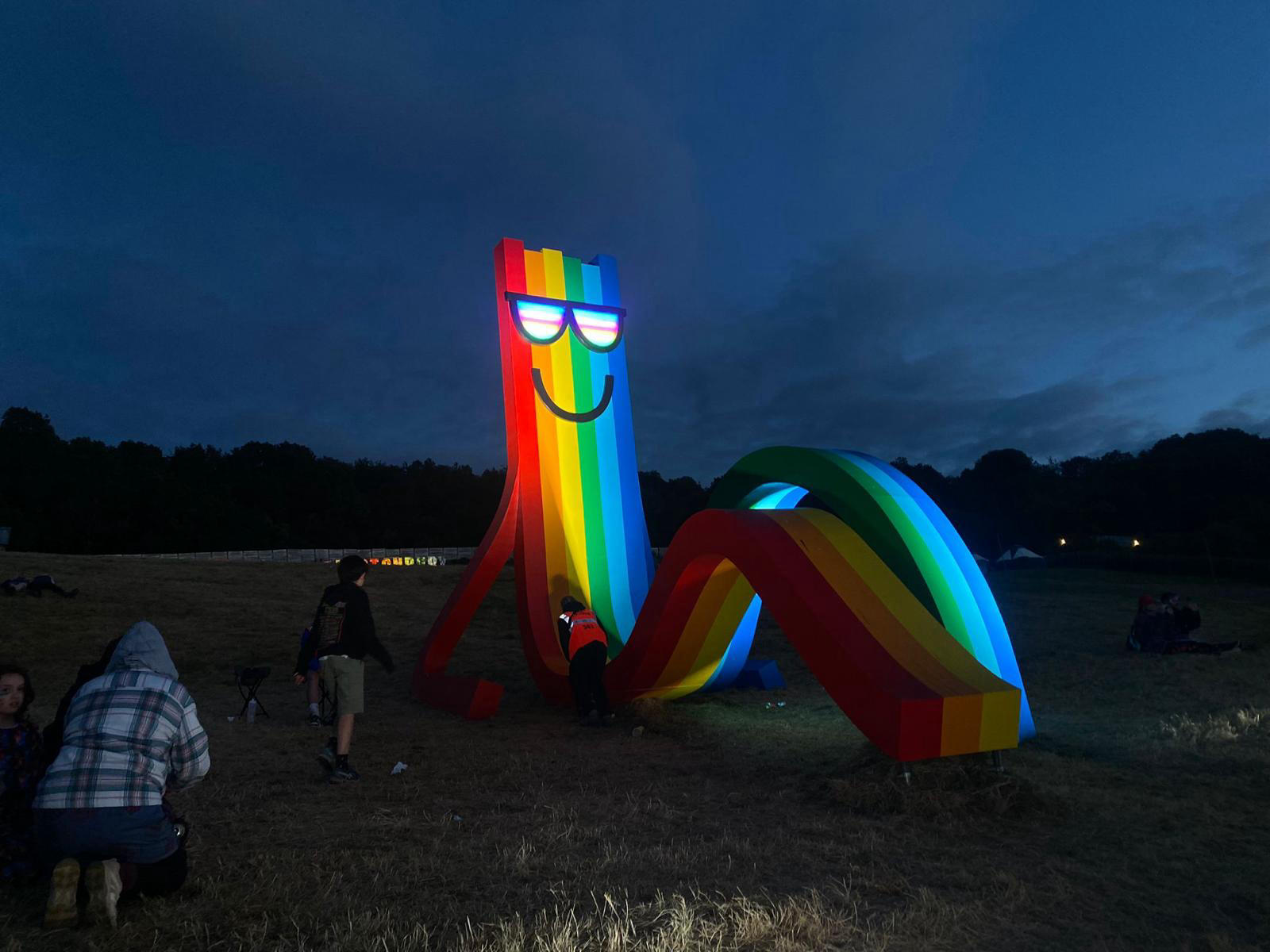 Image of Fixing Rainbow Dude's glasses at Glastonbury Festival