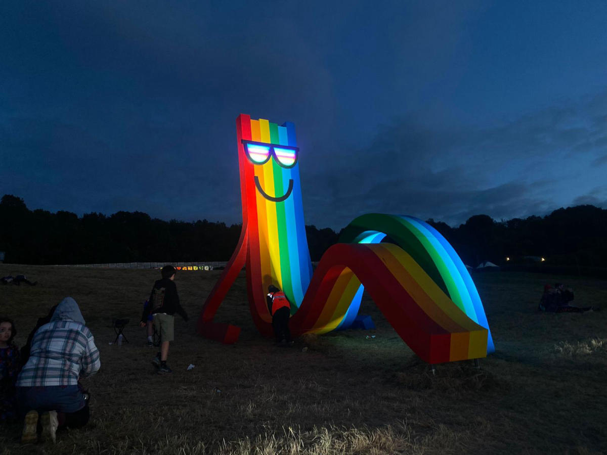 Fixing Rainbow Dude's glasses at Glastonbury Festival
